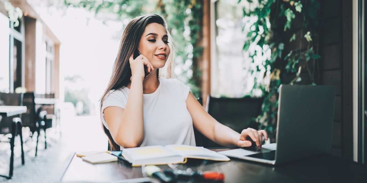 A self-employed woman typing on a laptop on the table, representing freelancers and entrepreneurs applying for a 1-year accounts mortgage in the UK.
