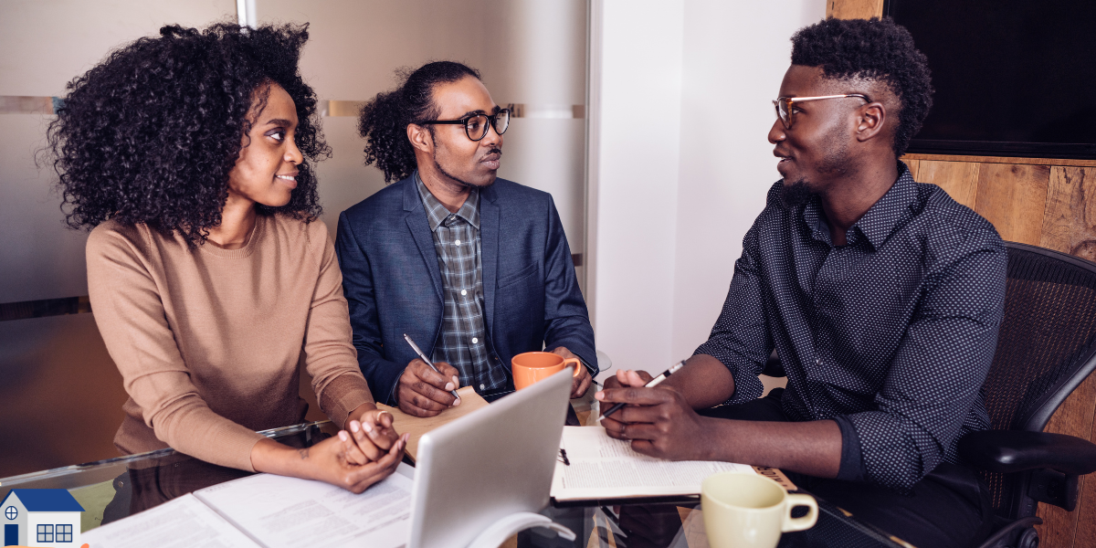 A financial advisor or professional consultant in a suit discussing financial documents with a young couple during a meeting about gifting a house deposit through equity release.