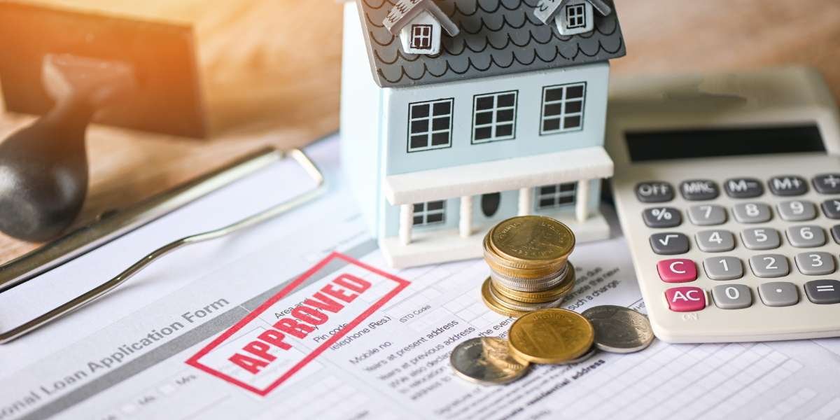 A miniature toy house, a stack of gold coins, and a calculator resting on a property loan application stamped "APPROVED," explaining the differences between regulated and unregulated bridging loans.