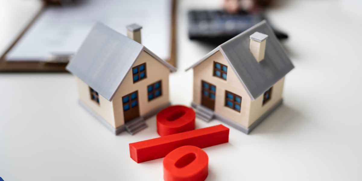 Two small model houses positioned behind a large red percentage symbol, highlighting how interest rates are impacted when applying for a bad credit mortgage in the UK.